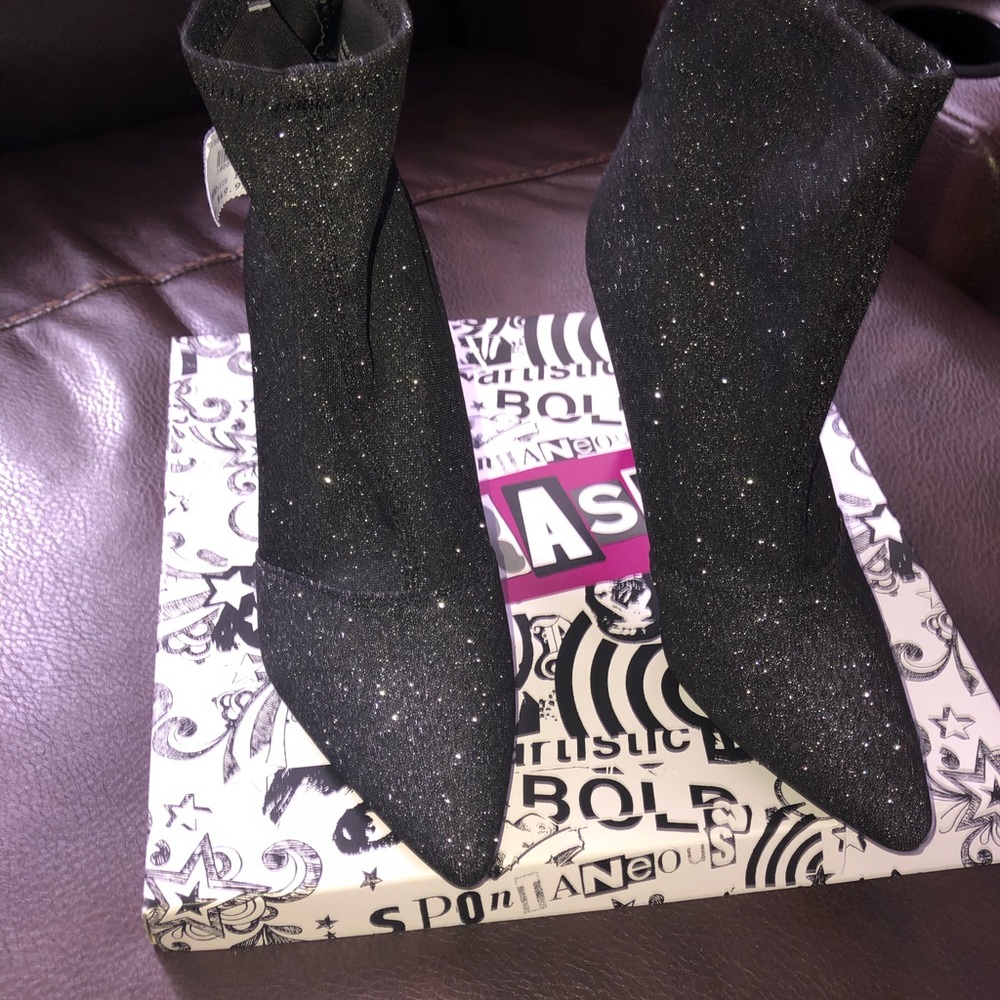 Black glitter high heel boots.